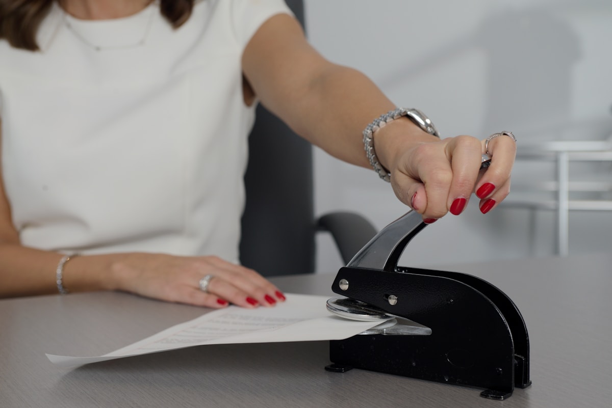 Professional applying a seal to an official document